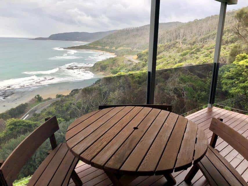 Balcony with round wooden table and chairs of Wye Escape Holiday Home Wye River overlooking the ocean