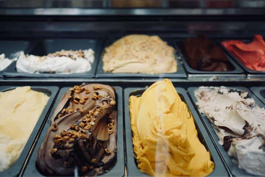 Different coloured and flavoured ice cream in black trays on display