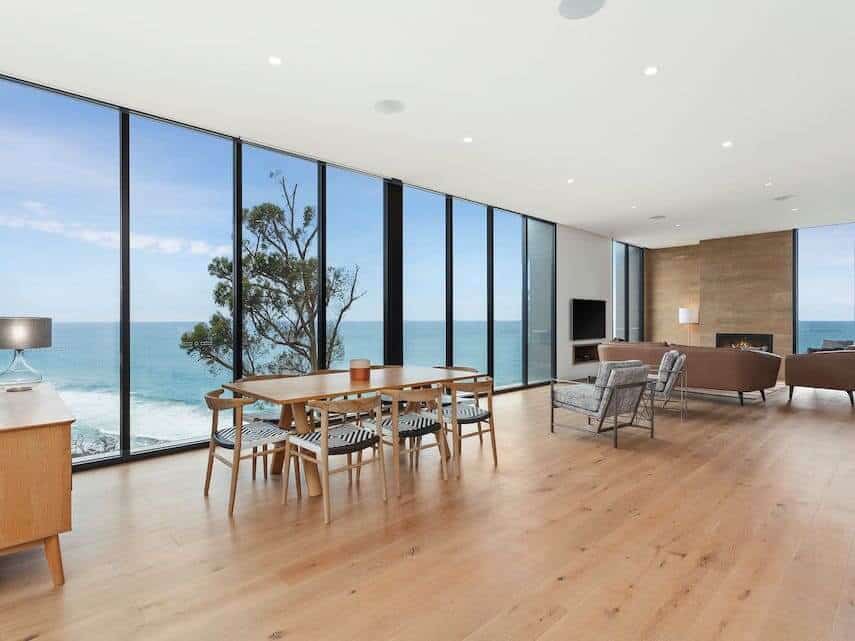 Iluka Blue Apartment with floor to ceiling windows looking out to the ocean, dining table with 6 chairs